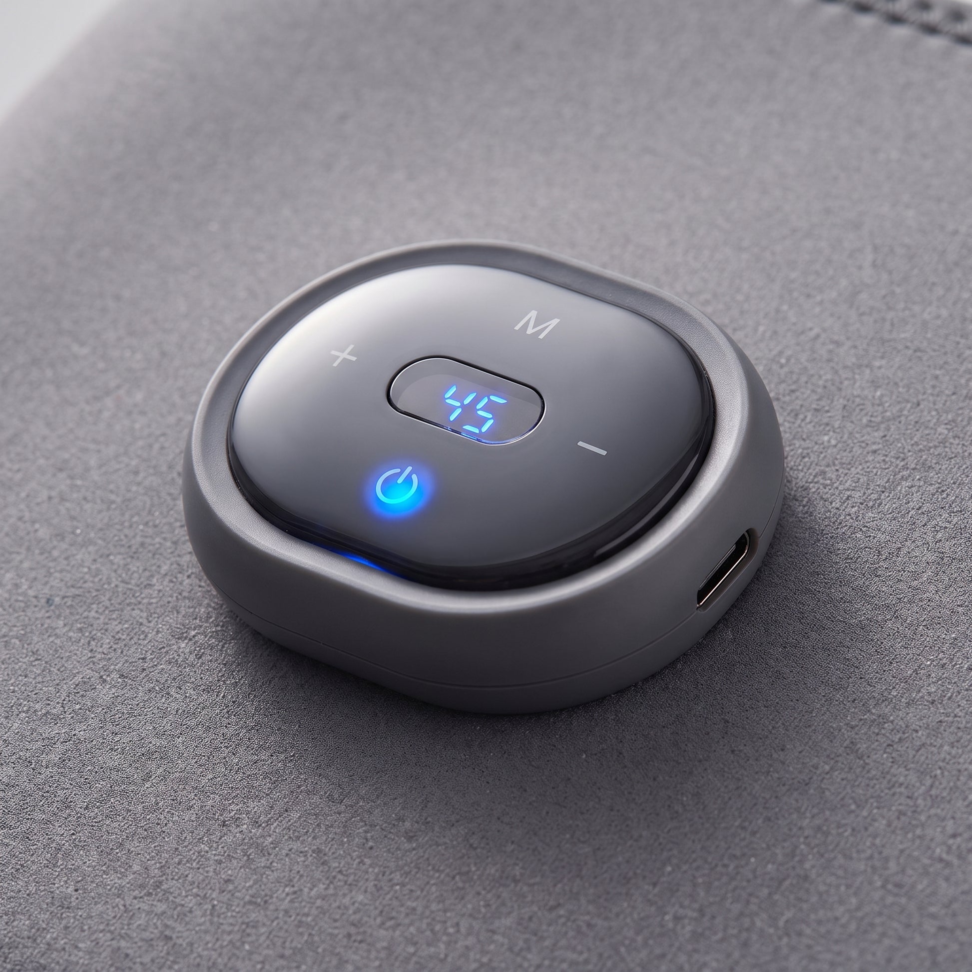 Close-up of the Velto Heated Knee Massager's detachable control unit with the display lit