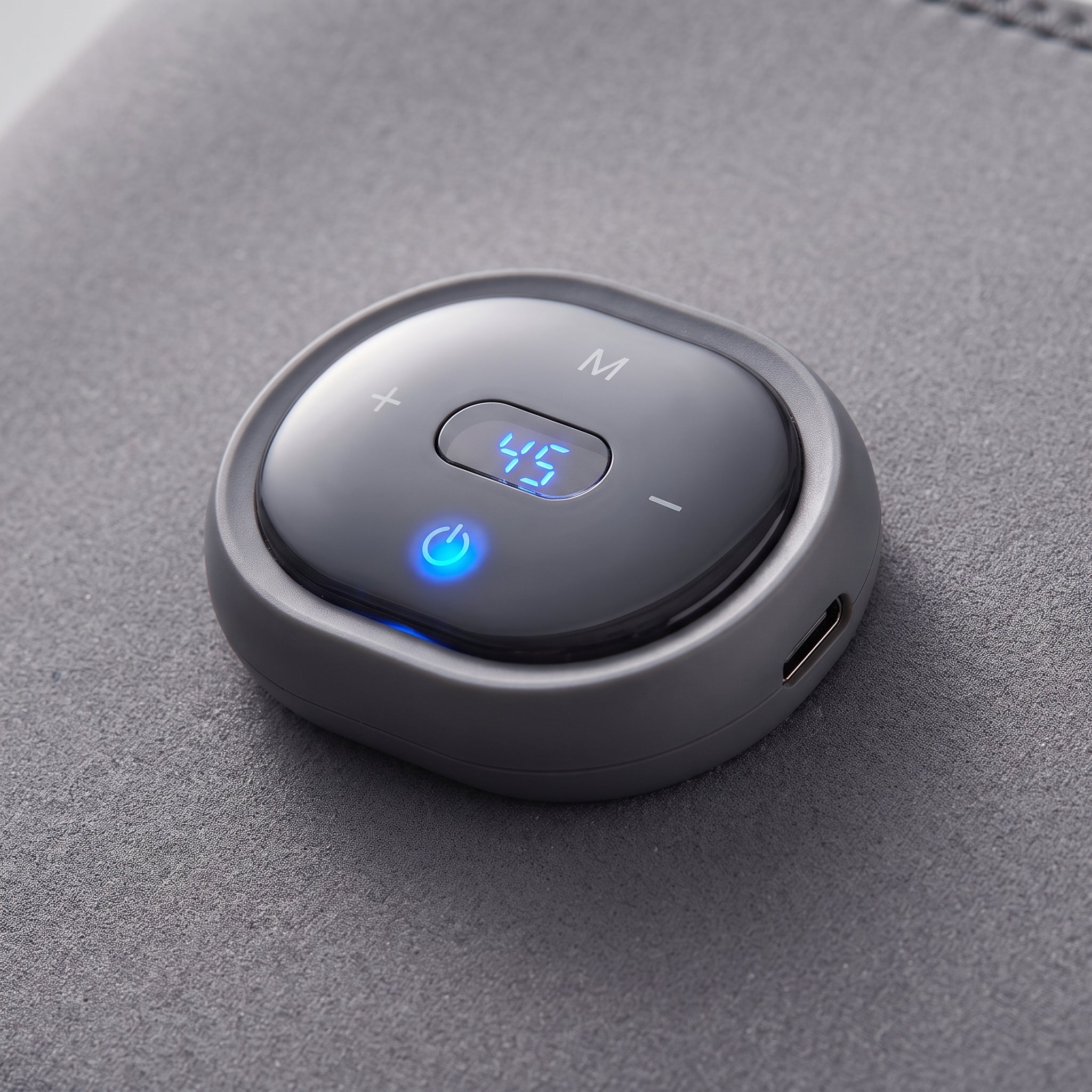 Close-up of the Velto Heated Knee Massager's detachable control unit with the display lit
